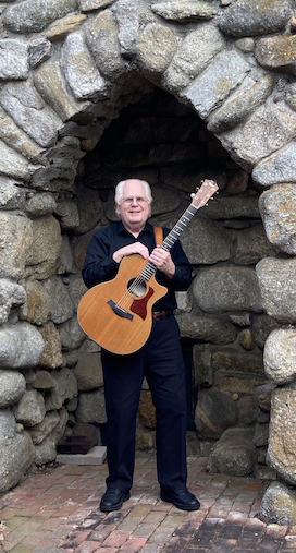 David with his guitar in a stone portal at Tor House in Carmel, California